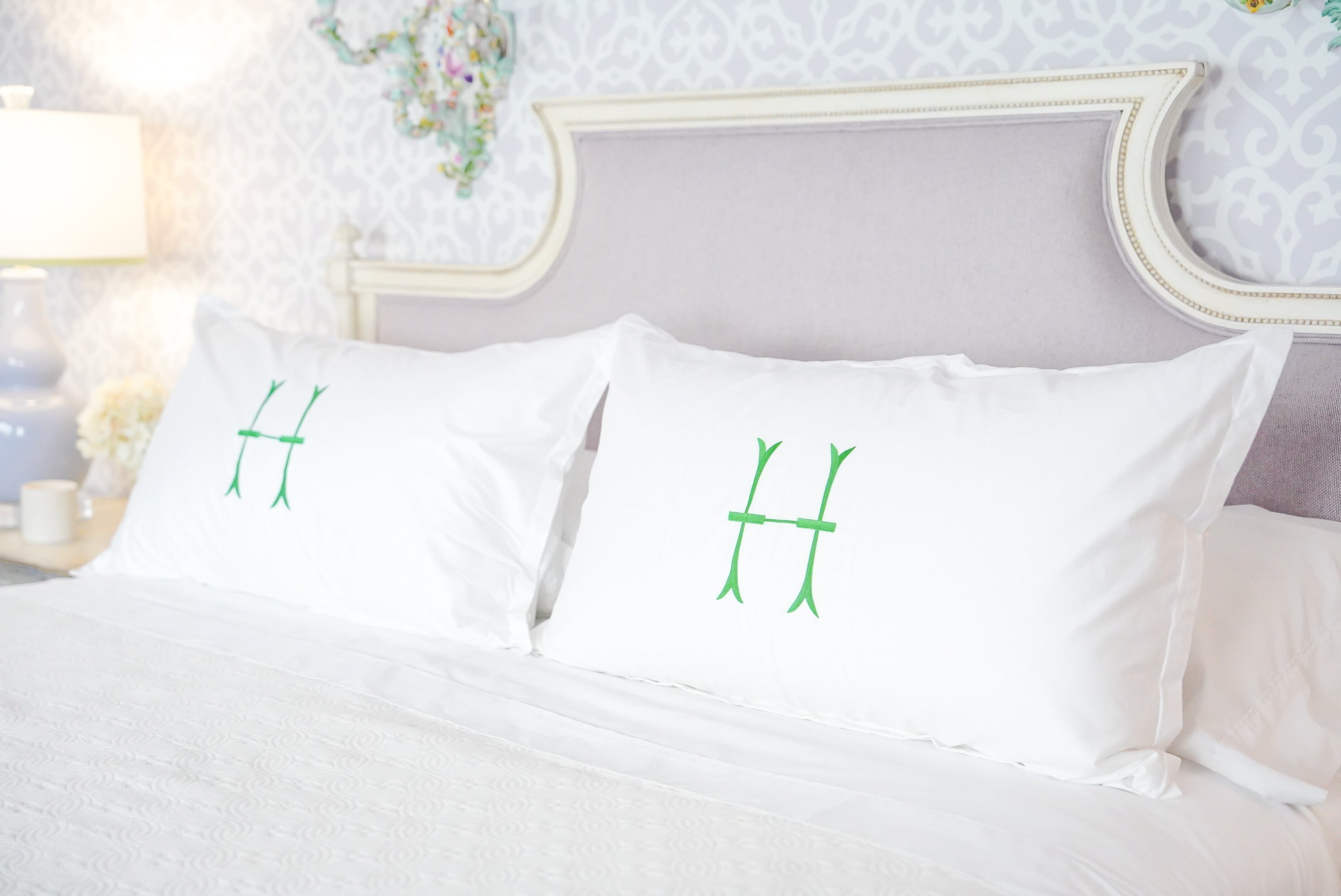 Caption: King Euro Shams with Lotus Monogram in Grass.