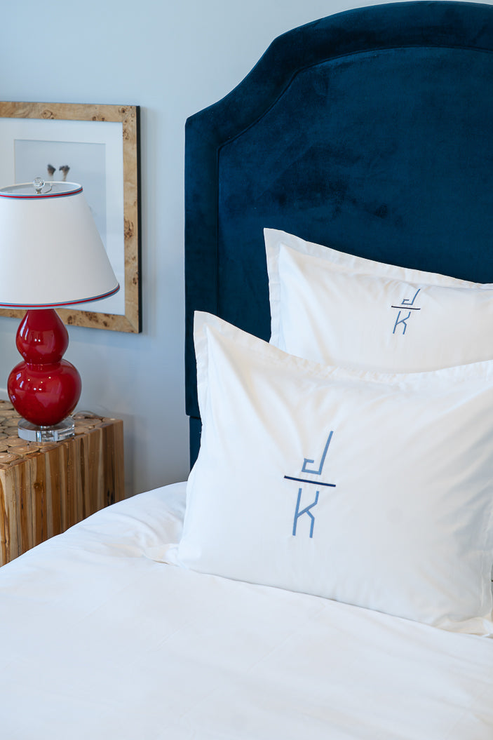 Caption: Euro (back) and Standard (front) Shams with Stacked Hugo monogram with Slate and Navy thread.