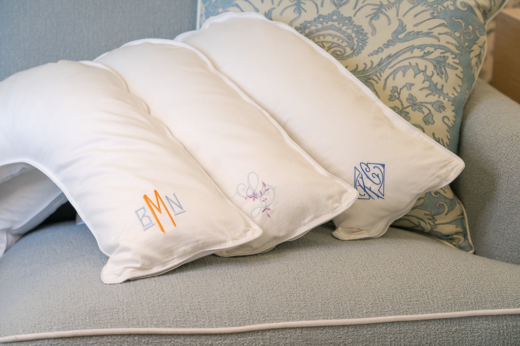 Caption: From left to right, monogram style is Hugo with Clementine and Light Blue thread; Eden with Glacier and Lilac thread; Margot with Ocean Blue thread.