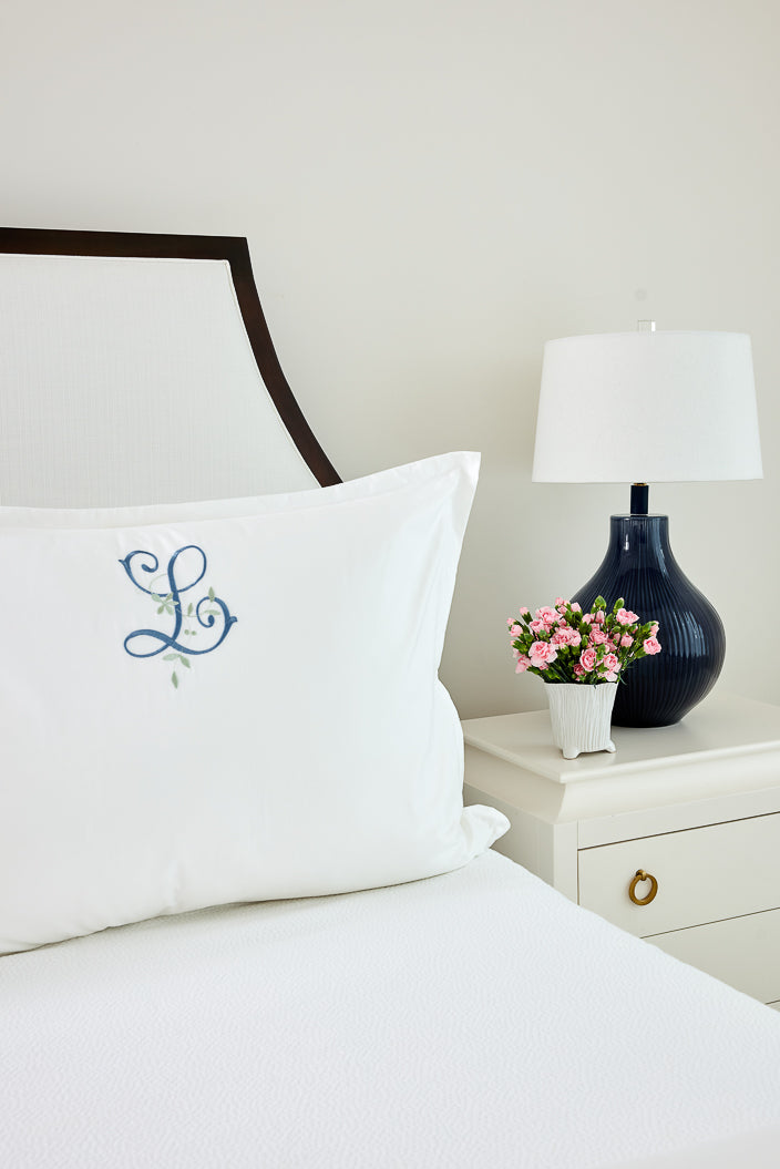 Caption: Royal Euro Sham with Eden Monogram style in Slate and Sage thread.