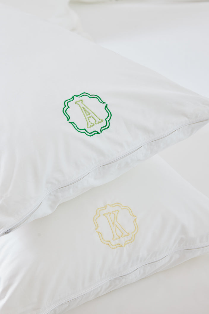 Caption: Monogram style is Poppy with Grass and Peridot thread; bottom pillow is Buttercup thread.