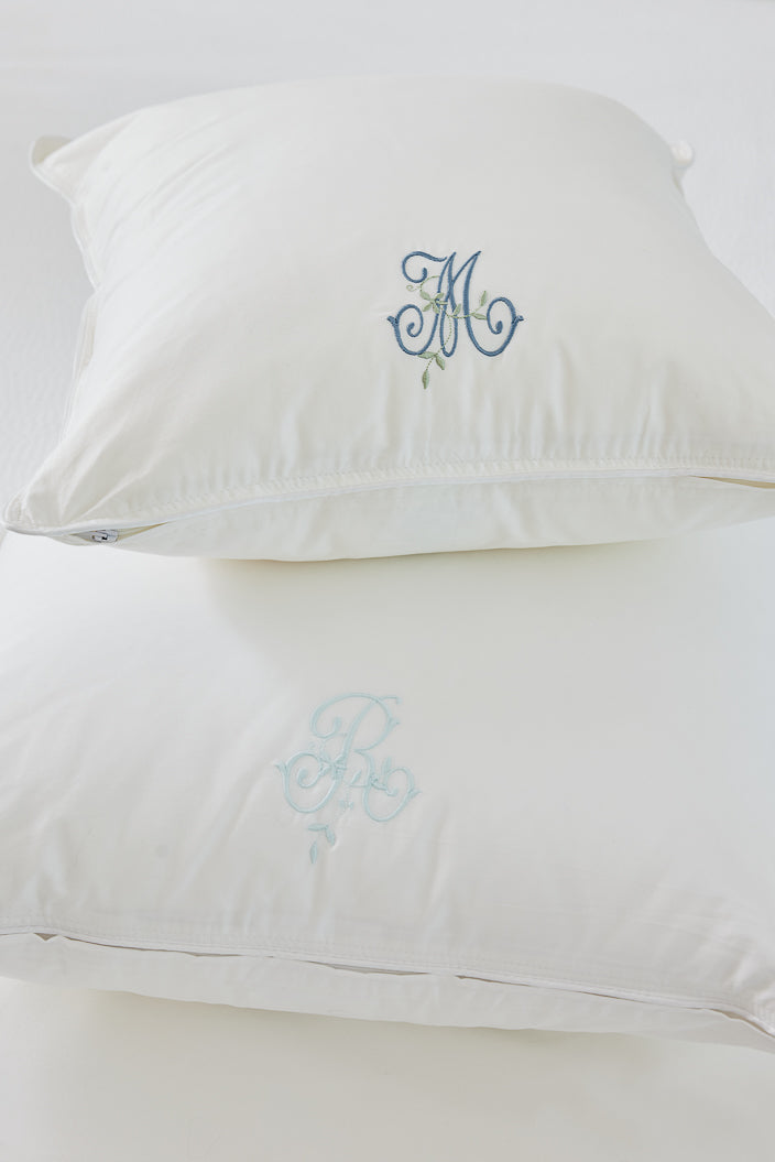 Caption: Monogram style is Eden with Slate and Sage thread on top pillow and Glacier thread on bottom pillow.